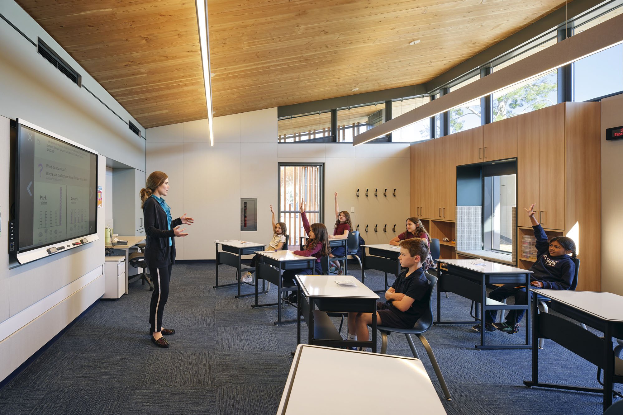 a classroom with a teacher and kids 