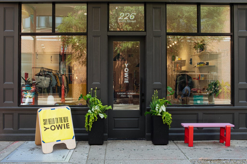 A storefront with a sign that says Say Hello to the New Yowie