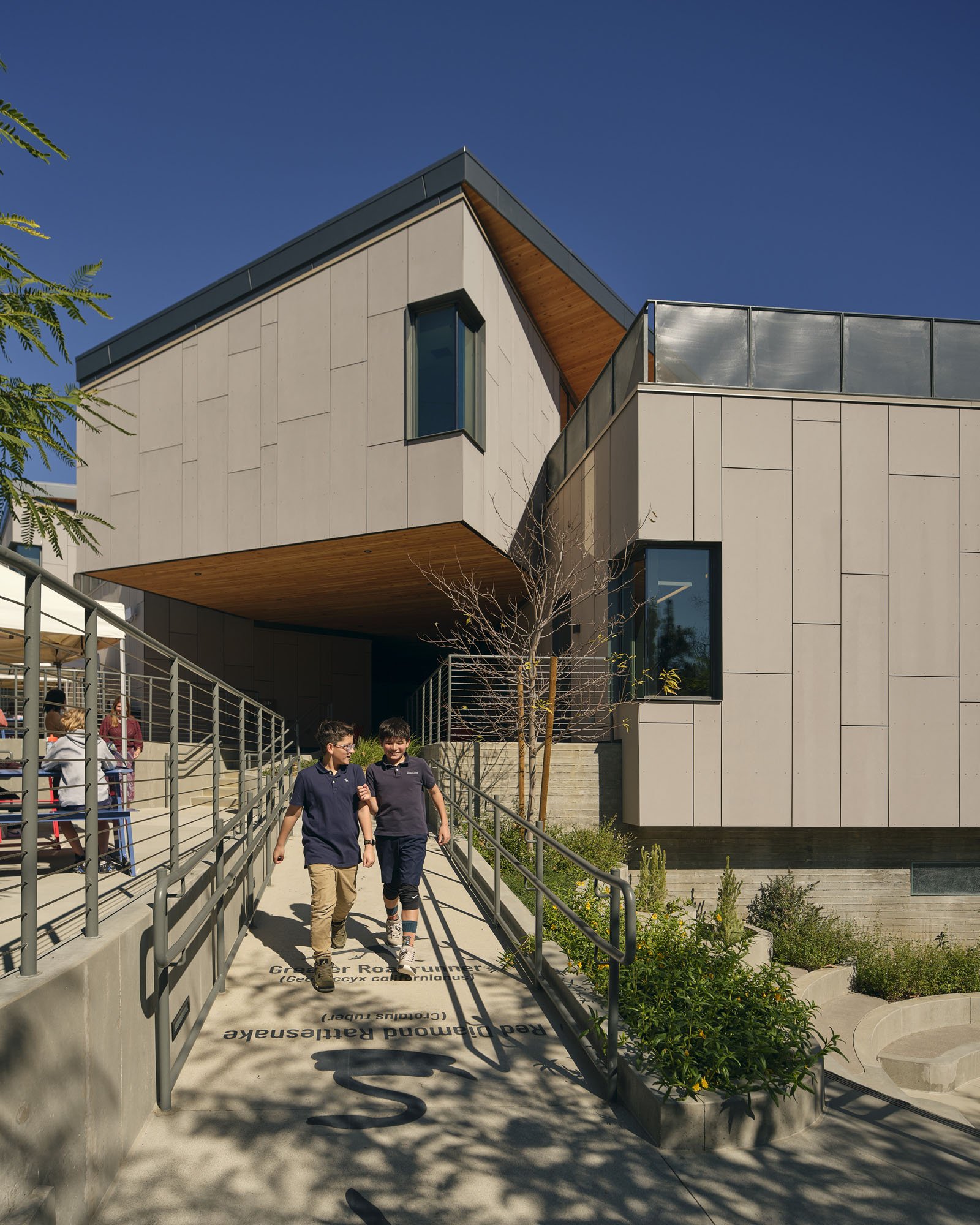 kids walking on a ramp to school