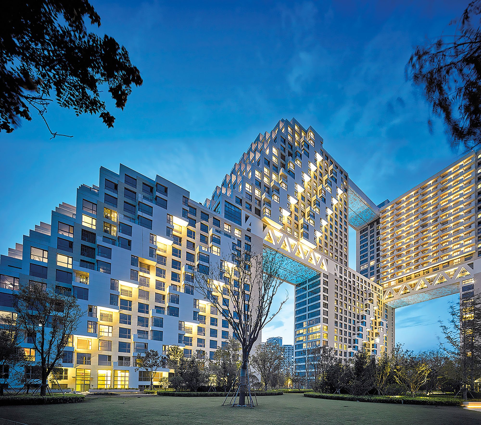 An exterior photograph of Habitat Qinhuangdao in the evening