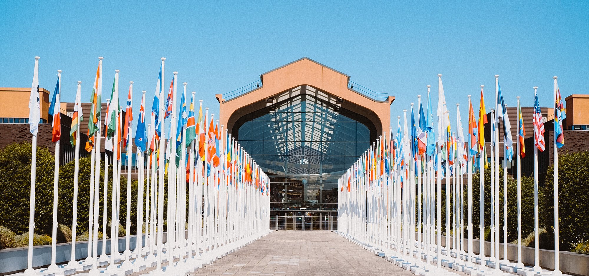 An entryway into the Olympic and Paralympic Village constructed for the 2024 Paris Olympics, with flags from all the nations