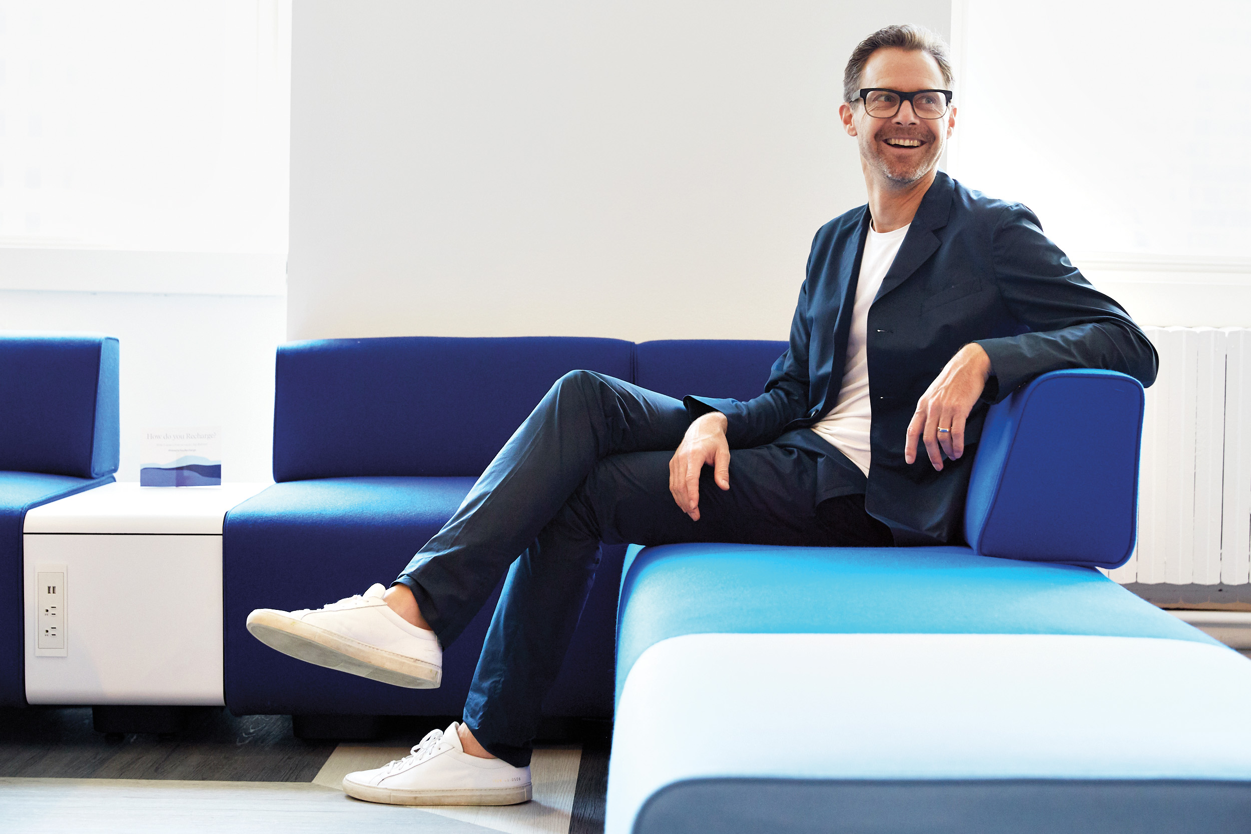 portrait of a man sitting on a blue couch