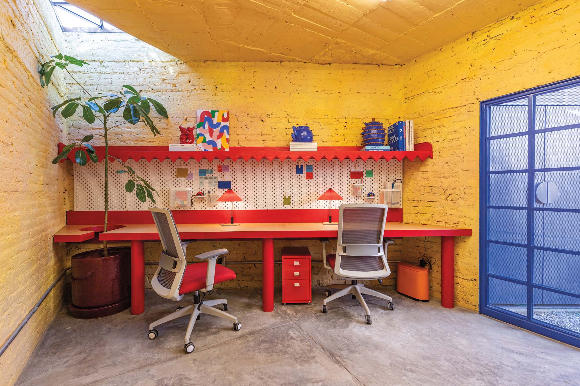 yellow walls provide striking contrast with the blue metal doors and red built-in furniture