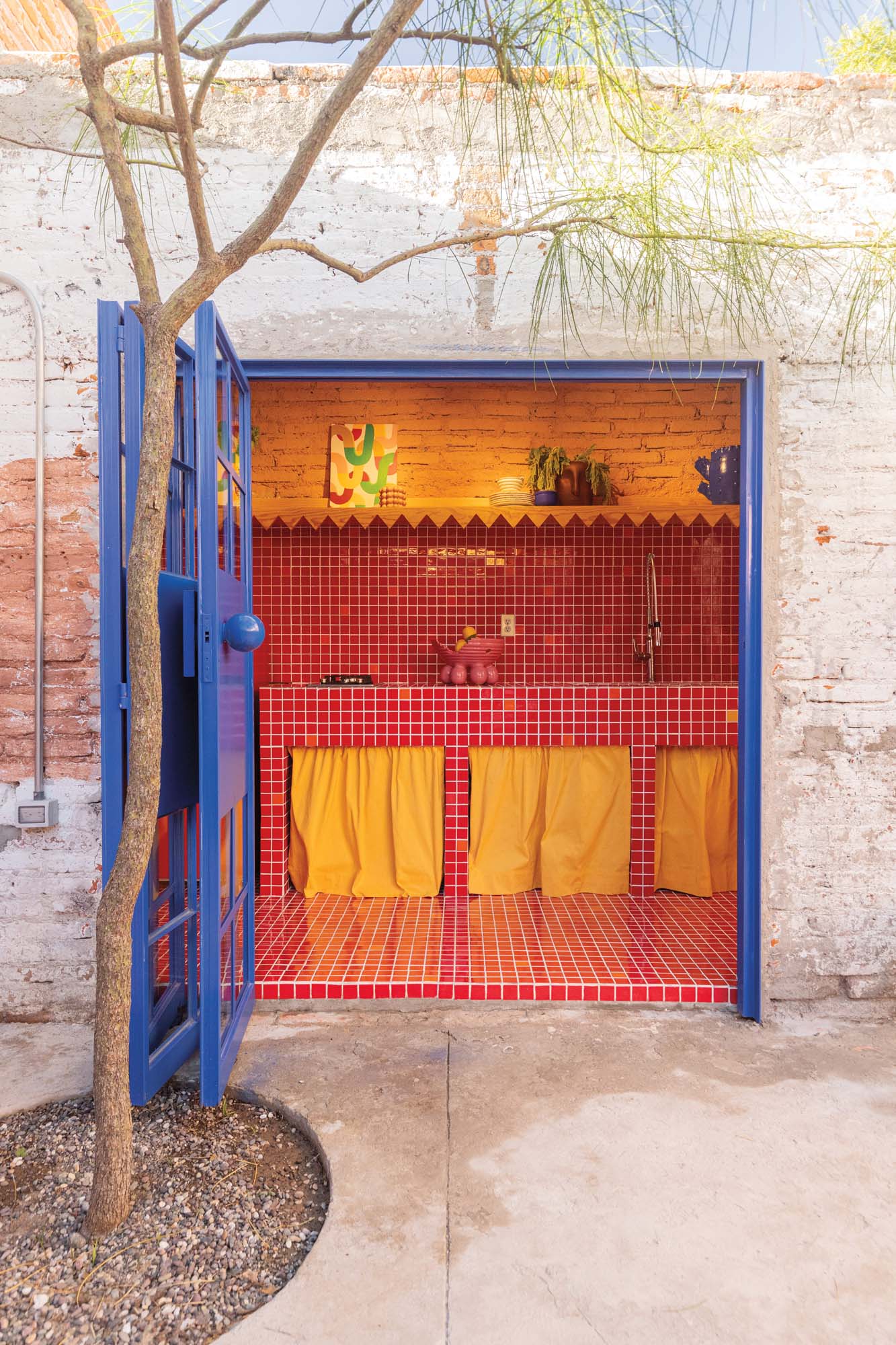 bright custom kitchen, saturated colors including reds evoke local historical buildings and murals