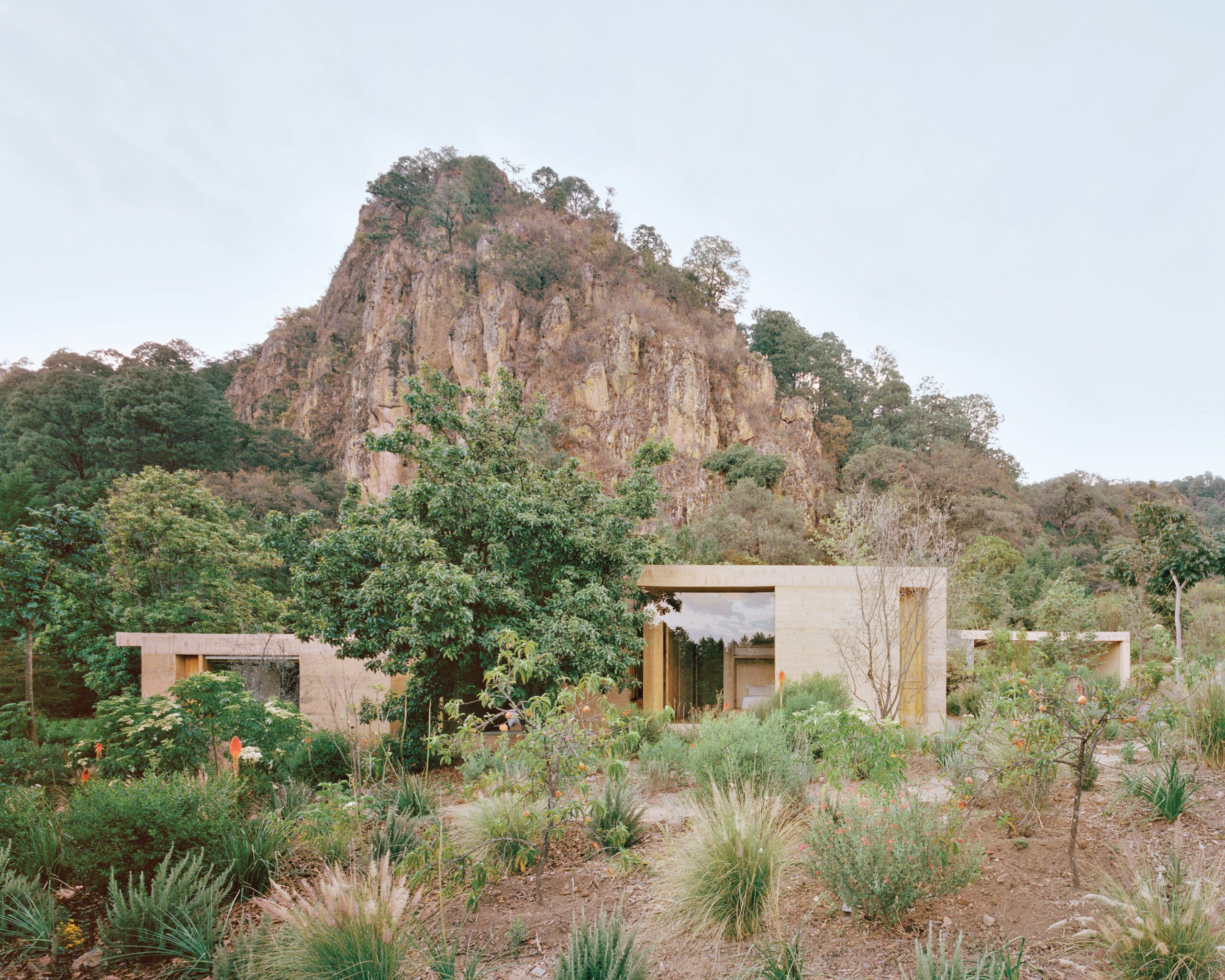image of a rammed earth building situated within it's landscape