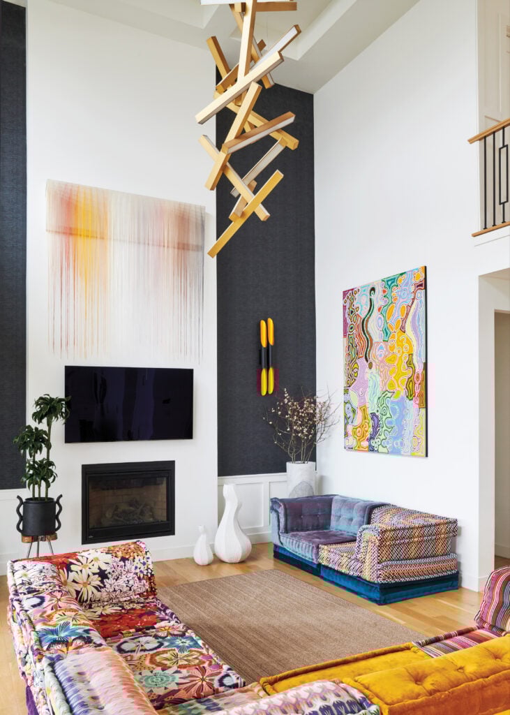 image of a living room with two sofas and various art on the walls