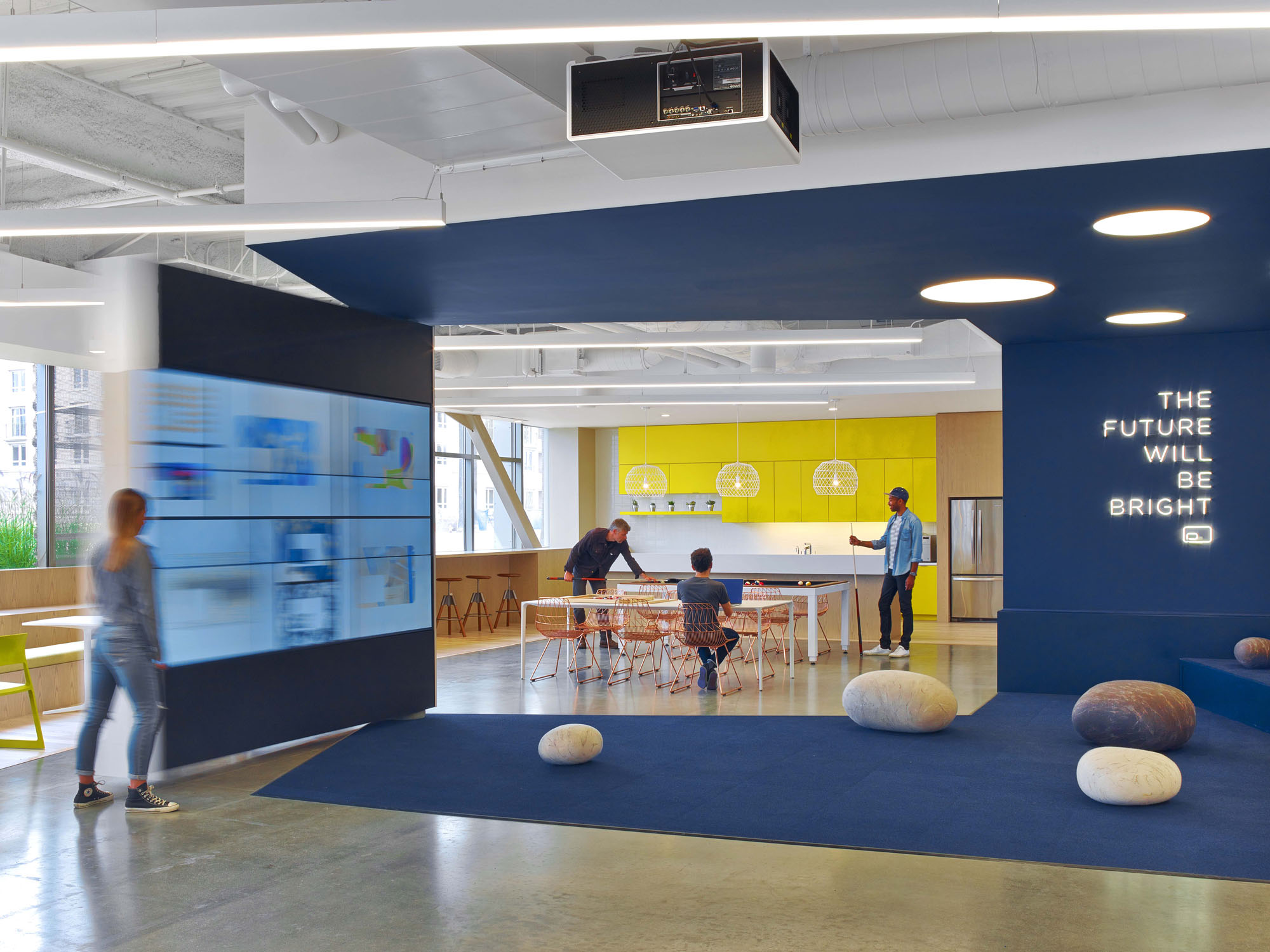 interior of office space with neon light graphic reading "The future will be bright"